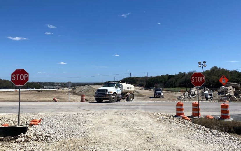 Oak Hill Parkway trucks use designated access points to enter and exit work zones. Stop sign installed near these construction entrances and exits help maintain safety along the US 290 corridor. April 2022